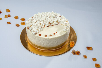 Round white cake on the special mirror stand