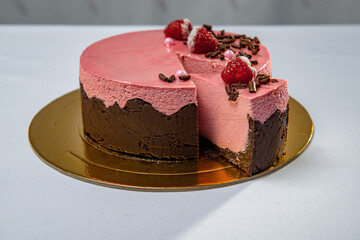 Round chocolate and strawberry cake with berries and chocolate flakes