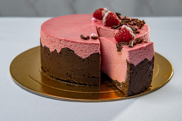 Round chocolate and strawberry cake with berries and chocolate flakes