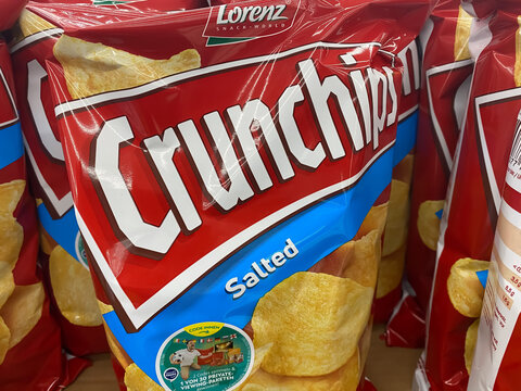 Viersen, Germany - May 9. 2021: Closeup of bag crunchips potato chips in german supermarket (focus on center of letter r left)