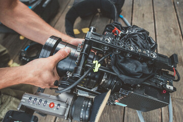 Fototapeta premium Professional film and video camera on the set. Shooting shift, equipment and group. Modern photography technique.