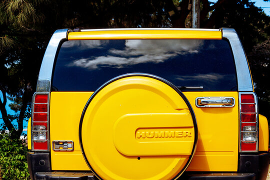 Hummer Logo On The Body (back) Of A Bright Yellow Car