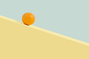 Summer orange fruit rolling on downhill. Abstract concept