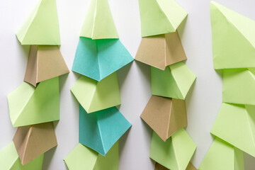 folded green blue and brown paper squares arranged in columns