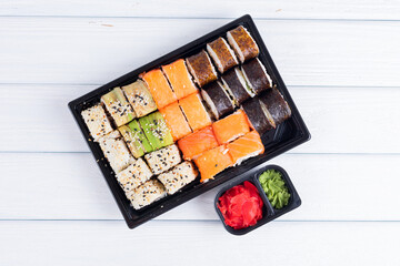 Delicious sushi set on white wood background