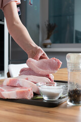 Raw meat on cutting board at the kitchen. Meat steaks