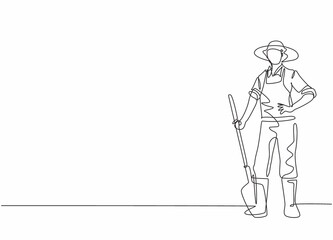 Obraz na płótnie Canvas Continuous one line drawing of young male farmer pose standing on field and holding shovel . Professional job profession minimalist concept. Single line draw design vector graphic illustration