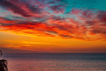 Fire sky over the ocean. Beautiful sunrise sky over the sea 