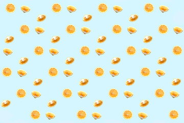 Bright colorful repetitive pattern made of lemon pieces on blue background. Minimal abstract concept flatlay .