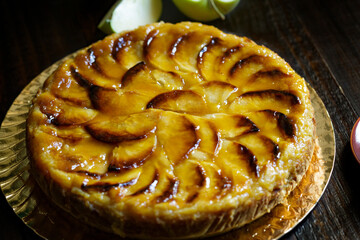 Homemade delicious fresh baked apple tart on wooden table.