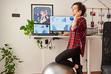 Woman telecommuting at an adjustable standing desk