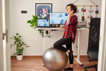 Woman telecommuting at an adjustable standing desk