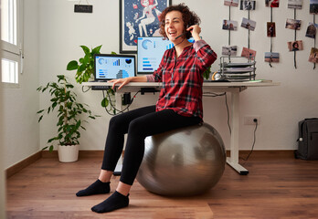 Woman teleworking sitting on a fitball