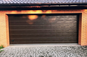  Garage door. Large automatic up and over door. Close- up photo, natural light.