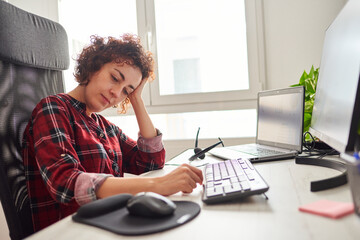 Tired woman working in front of computer