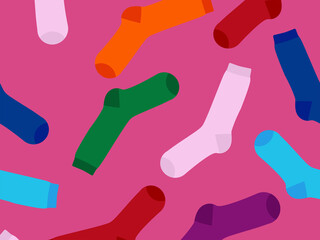 Multi-colored socks on a pink background, pattern. View from above. Many different socks for cold seasons. Socks are scattered on a bright background.