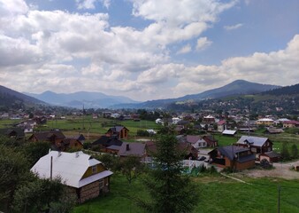 Obraz premium View of the village Verkhovyna in the mountains. Houses and Green hills. Summer in Carpathian mountains. Ukraine. Europe