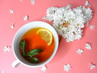 Fragrant tea with lemon and flowers.