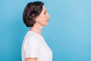 Side profile photo portrait senior woman looking copyspace serious strict isolated pastel blue...