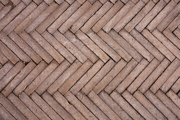 Texture of old herringbone road tiles. Paving stone floor template for background.