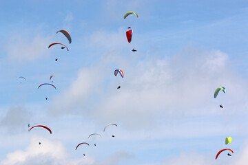 Paragliders in a blue sky