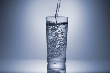 A glass of clean drinking water being filled