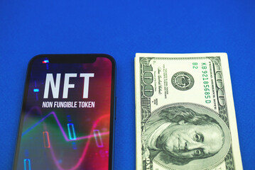 NFT token and dollar bills money on the table, future of crypto art cryptocurrency blockchain concept photo