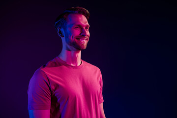 Profile side view portrait of attractive cheerful virile guy isolated over dark neon light violet color background