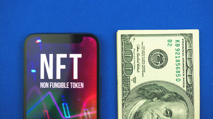 NFT token and dollar bills, money against future of new virtual and future crypto currency and crypto art, top view and blue background photo