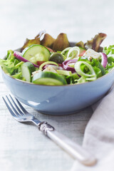 Salad with Green Olives, Cucumber and Feta Cheese. Bright wooden background. 