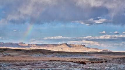 arid desert landscape with a rainbow in Utah near town of Green River
