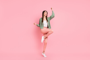 Full size photo of hooray girl dancing wear sweater trousers sneakers isolated on pink color background