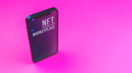 Concept of NFT marketplace on the mobile phone, smartphone with crypto art store, NFT non fungible...
