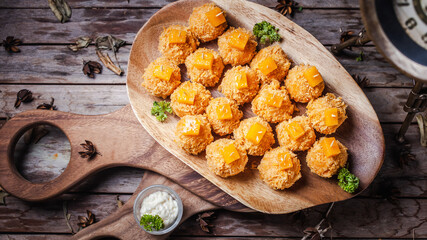 The cheese spread is ball-shaped, usually served at Christmas in the United States and Canada. top view