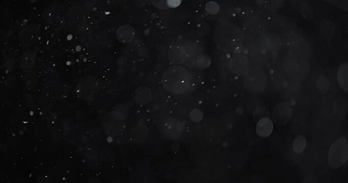 Floating abstract particle bokeh on dark background