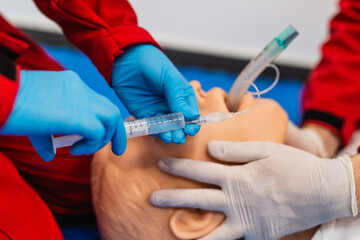 Side view of help emergency with complications in the respiratory tract. introduction endotracheal tube (ETT) into trachea ensure airway patency. Medical student performs procedure exam.