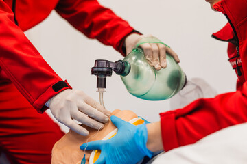 First Aid Training - CPR training medical procedure, Using an oxygen mask on a CPR dummy. Paramedics practice first aid