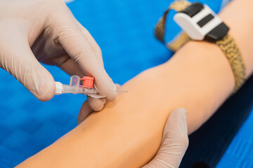 Medical technologist doing a blood draw services for patient. First aid and doll