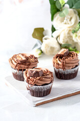 Chocolate cupcakes with decoration on white background