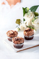 Chocolate cupcakes with decoration on white background