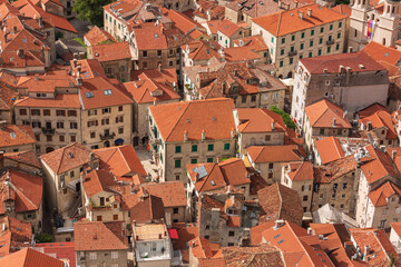 Fototapeta na wymiar Close-up top view of the old roofs with red tile, the old town of Kotor in Montenegro