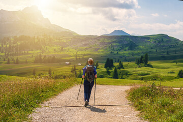 Young woman hiking and going camping in nature. Trentino, Italy