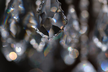 Fragment of crystal chandelier with highlights and beautiful bokeh. Shallow depth of field