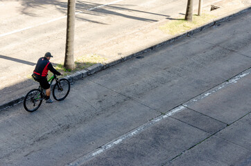 Naklejka premium a bicyclist riding on an empty street