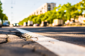 Sunny day in a city, view of the flow of cars to the road level