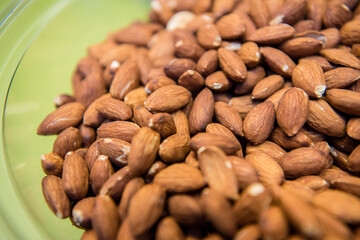 Organic almonds in a see through serving bowl. Top view