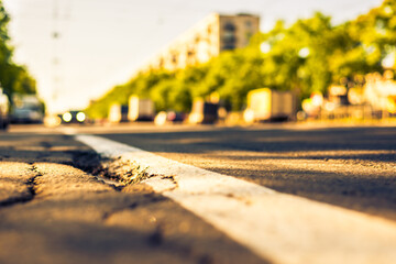 Sunny day in a city, view of the flow of cars to the road level