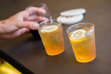 Hand holding fresh cold draught sour beer with lemon