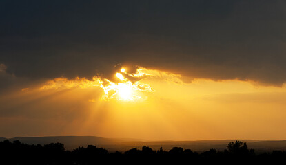 Sunset on a cloudy day over a city