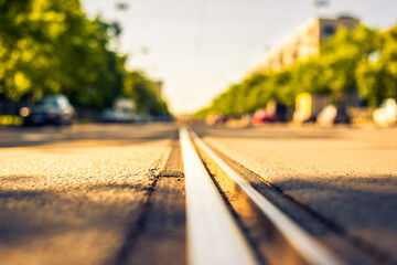 Sunny day in a city, view of the flow of cars approaching from the level of the tram rails